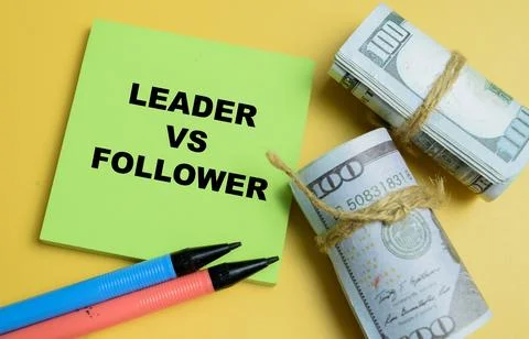 Concept of leader vs follower write on sticky notes isolated on table. Stock Photos