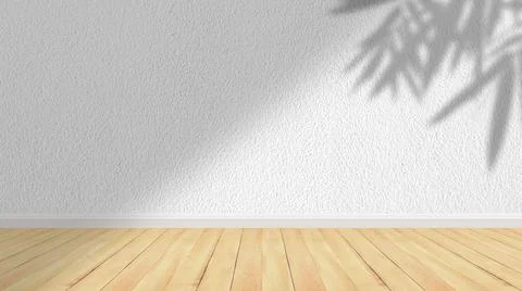 Concept of leaf shadow and light on gray cement wall and wooden floor. Stock Photos