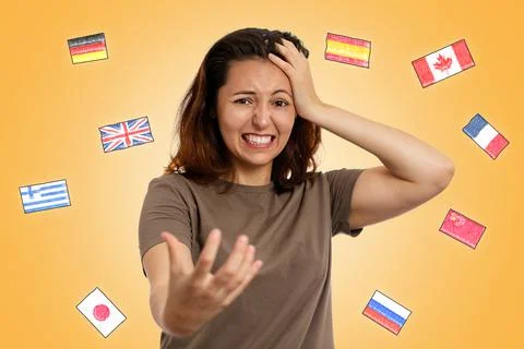 The concept of learning foreign languages. A young woman clutches her head, e Stock Photos