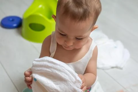 The concept of learning to use the chamber pot. close-up: a little cute baby Stock Photos