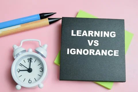 Concept of learning vs ignorance write on sticky notes isolated on table. Stock Photos