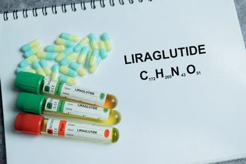 Concept of liraglutide injection write on book isolated on Wooden Table. Stock Photos