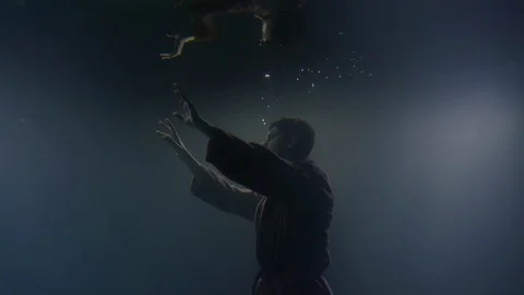 Concept. Lonely drowning man floating underwater in dakrness, Video stock 105213912