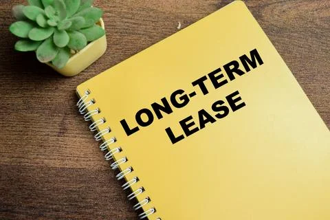 Concept of Long-Term Lease write on book isolated on Wooden Table. 스톡 사진