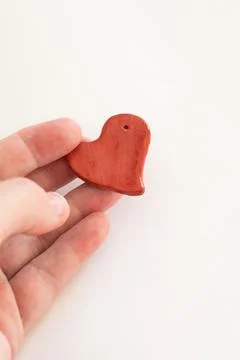 Concept love, valentines day. Hand with small red heart Stock Photos