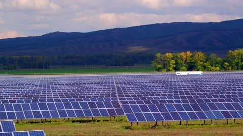 The concept of low-cost and efficient solar energy. Solar panels, mountains in Stock Footage 156696750