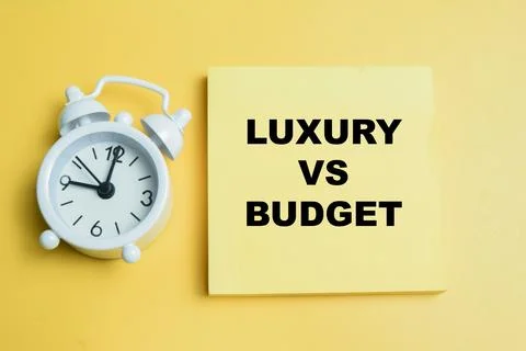 Concept of luxury vs budget write on sticky notes isolated on table. Stock Photos