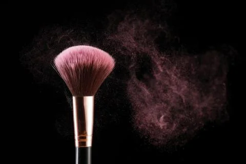 Concept of makeup brush and dusting. Stock Photos