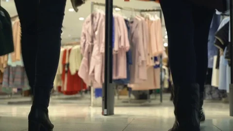 Concept mall shopping. Legs silhouette of shoppers on background clothing store Stock Footage