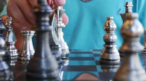 Concept of Man playing silver chess Stock Footage 64098036