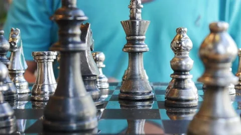 Concept of Man playing silver chess Stock Footage 64099551