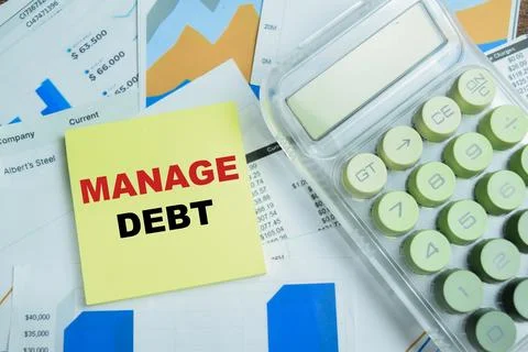 Concept of manage debt write on sticky notes isolated on Wooden Table. 스톡 사진
