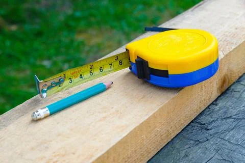 The concept of measuring work in construction with wood material. Horizontal Stock Photos