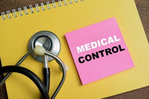 Concept of medical control write on sticky notes isolated on Wooden Table. Stock Photos