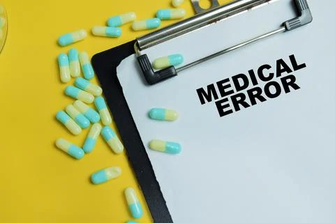 Concept of medical error write on clipboard isolated on table. Stock Photos