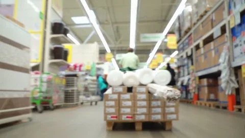 Concept men shopping in construction hypermarket. The loader is driving through Stock Footage 76025241