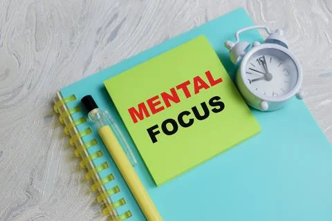 Concept of mental focus write on sticky notes isolated on Wooden Table. Stock Photos
