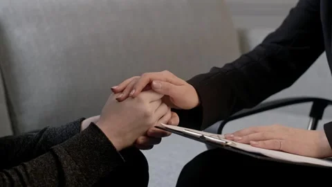 Concept of mental health problems. Close up shot psychologist put arms to Stock Footage 264098360