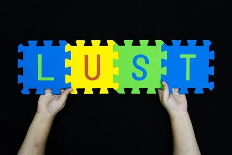 Concept message lust on foam blocks being held for creative or teaching purpo Stock Photos