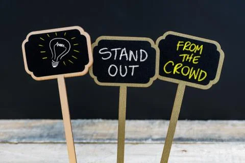 Concept message STAND OUT FROM THE CROWD and light bulb as symbol for idea  Stock Photos