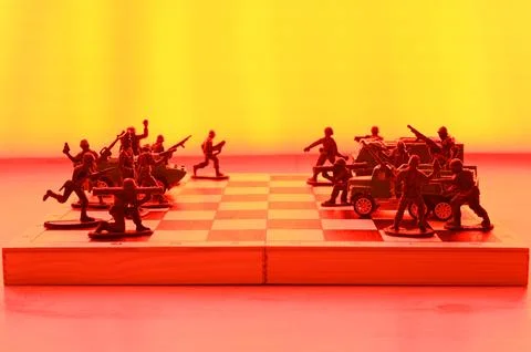 Concept of military aggression on the chessboard. Stock Photos
