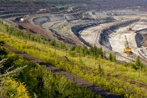 Concept of mineral development - open-pit mining of iron ore. Stock Photos