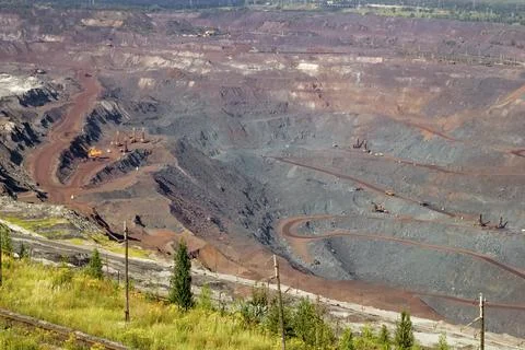 Concept of mineral development - operating mine extraction of iron ore. Stock Photos