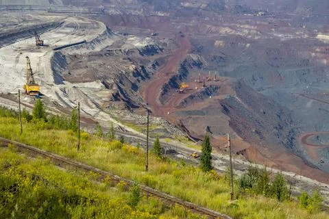 Concept of mineral development - panorama of operating ore mine. Stock Photos