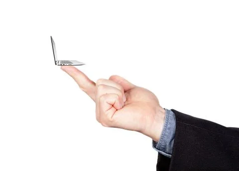 The concept of minimalism in computerization. Miniature laptop on his finger. Stock Photos
