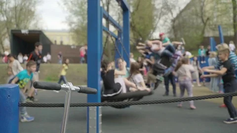Concept of modern children's outdoor games. Children swinging on a swing. Kids Stock Footage