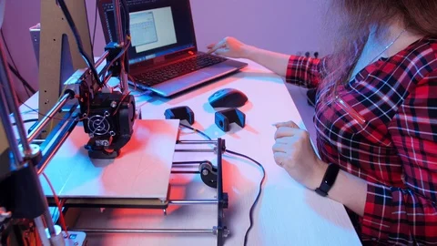 Concept of modern production technologies. Young woman student makes the item on Stock Footage 114964243
