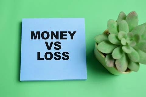 Concept of money vs loss write on sticky notes isolated on table. Stock Photos