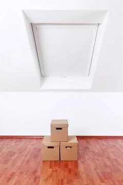 Concept of moving and assembling - empty room with moving boxes Concept of... Stock Photos