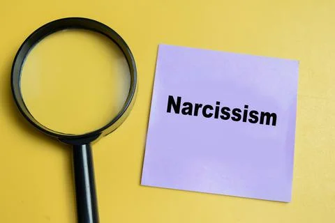 Concept of narcissism write on sticky notes isolated on table. Stock Photos