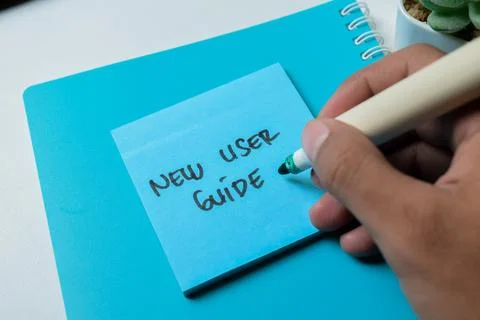 Concept of New User Guide write on sticky notes isolated on white background. 写真素材