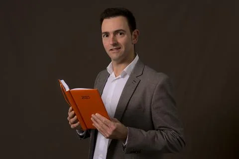 Concept new year resolution. Handsome entrepreneur reads business plan on 2023 Stock Photos