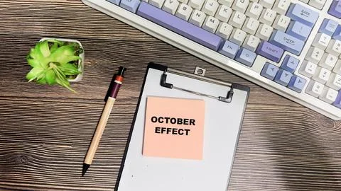 Concept of October Effect write on sticky notes isolated on Wooden Table. Stock Photos
