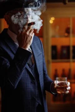 Concept of old age wisdom and experience. Old man with cigar and Stock Photos
