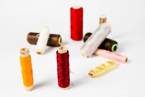 Concept of old fashioned tailoring threads - colors, red, yellow, white, brow Stock-Fotos
