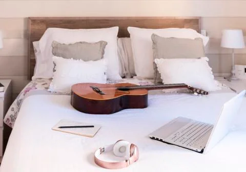 Concept of online classes. Bedroom with a computer and a guitar. Focus on the Stock Photos