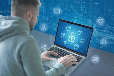 Concept of online security. Guy work on computer with conceptual icons of sec Stock Photos