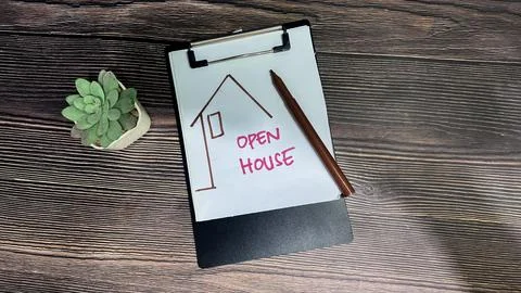 Concept of Open House write on paperwork isolated on wooden background. Fotos de archivo