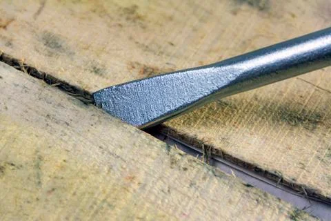 The concept of opening the box. The tip of the mounting tool is inserted into Stock Photos