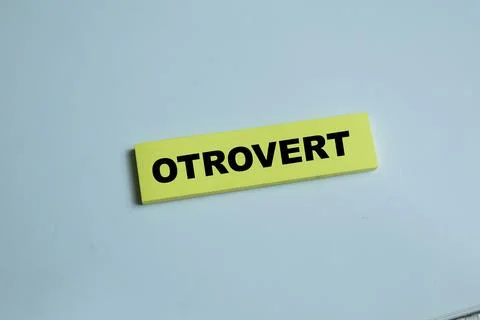 Concept of otrovert write on sticky notes isolated on Wooden Table. Stock Photos