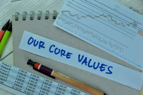 Concept of Our Core Values write on sticky notes isolated on Wooden Table. Stock Photos