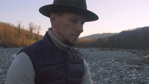 The concept of outdoor recreation. A man in a hat is drinking beer from a bottle Stock Footage 123210853