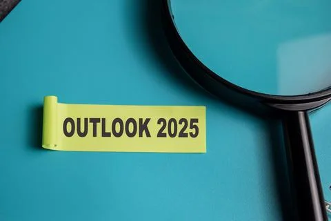 Concept of Outlook 2025 write on sticky notes isolated on Wooden Table. Stock Photos