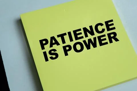 Concept of patience is power write on sticky notes isolated on Wooden Table. Stock Photos