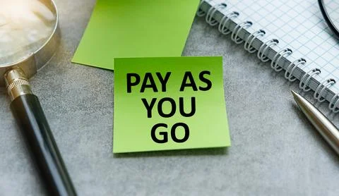 Concept of Pay As You Go write on sticky notes with Calculator isolated on .. Foto stock