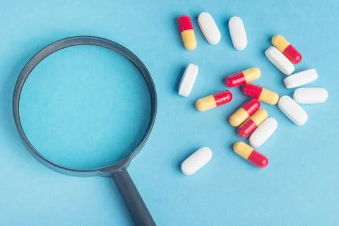 Concept - pharmaceutical testing, testing of medicines, magnifying glass, tab Stock Photos